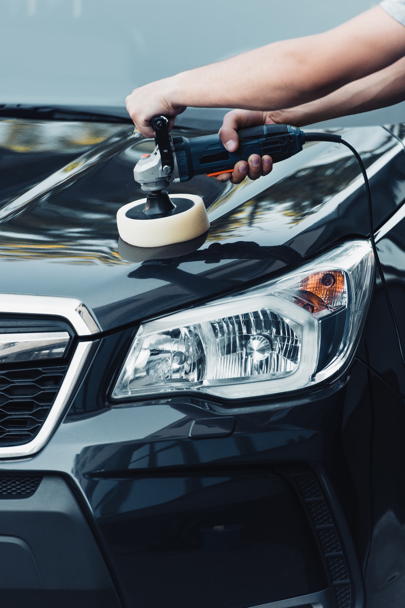 Close-up of a polisher working paint during paint correction