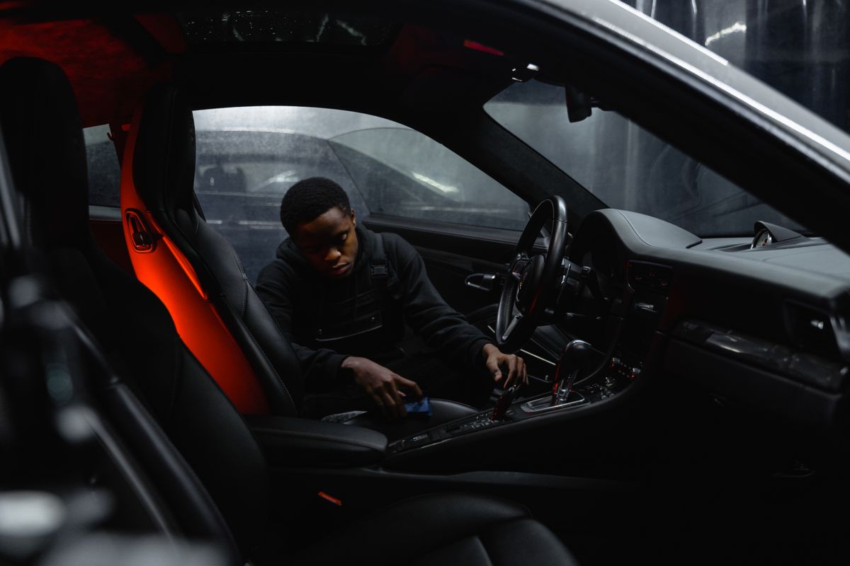 Detailer cleaning a car centre console