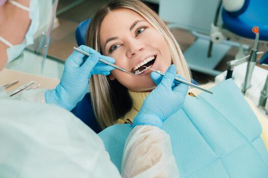 Dentist treating a patient wearing a protective mask