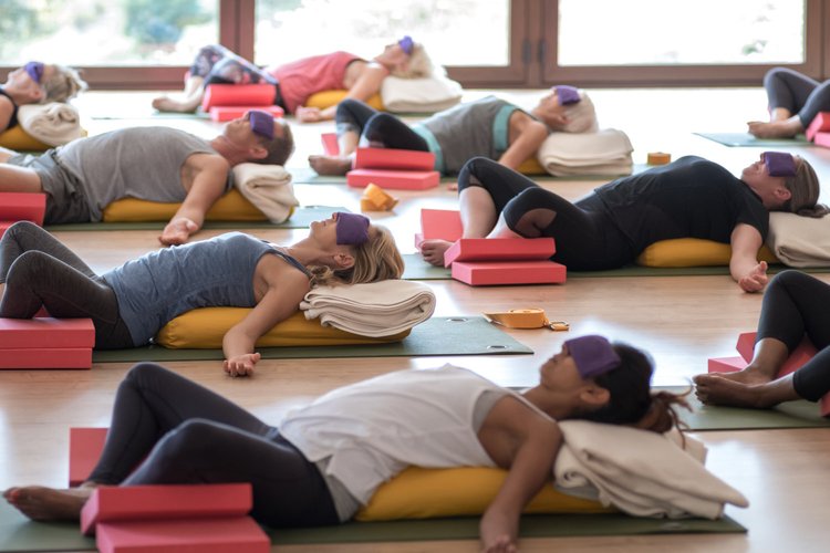 Restorative class with bolsters and eye pillows